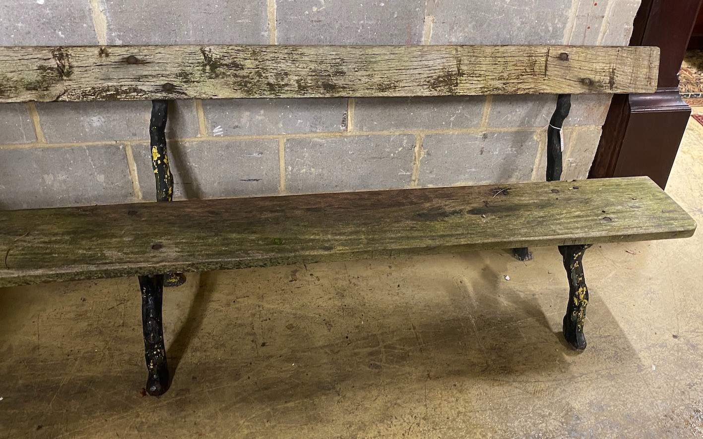 A Victorian cast iron garden bench with rustic ends and teak seat, length 305cm, depth 60cm, height 81cm